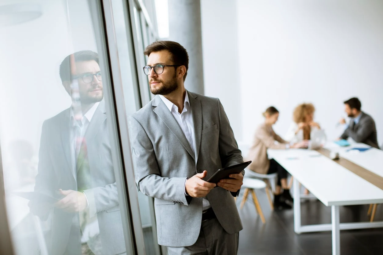 Young modern businessman using digital tablet in the office