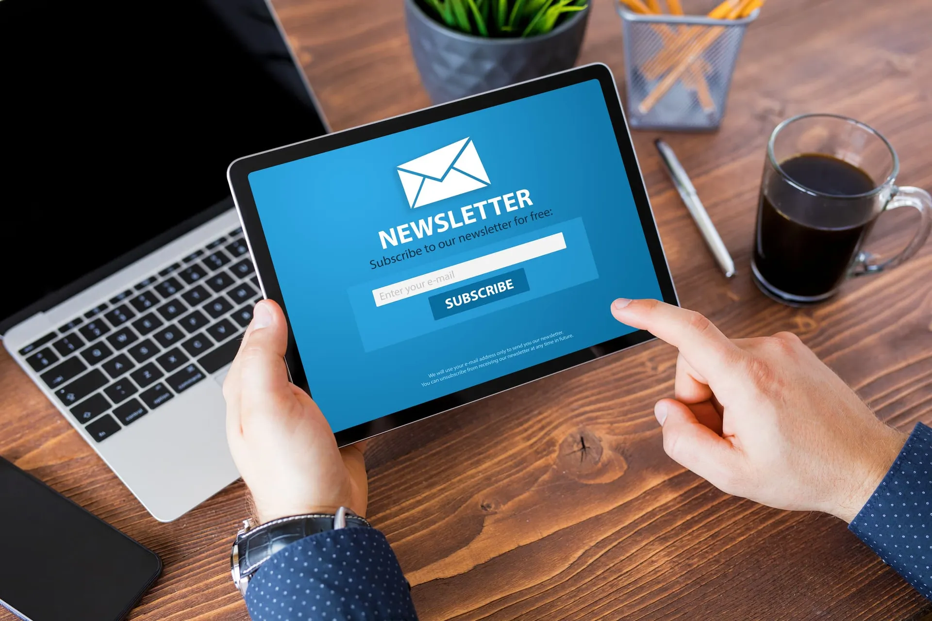 Man viewing newsletter signup page on tablet computer