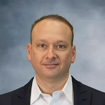 DanK_headshot_2025_gray background_400x400