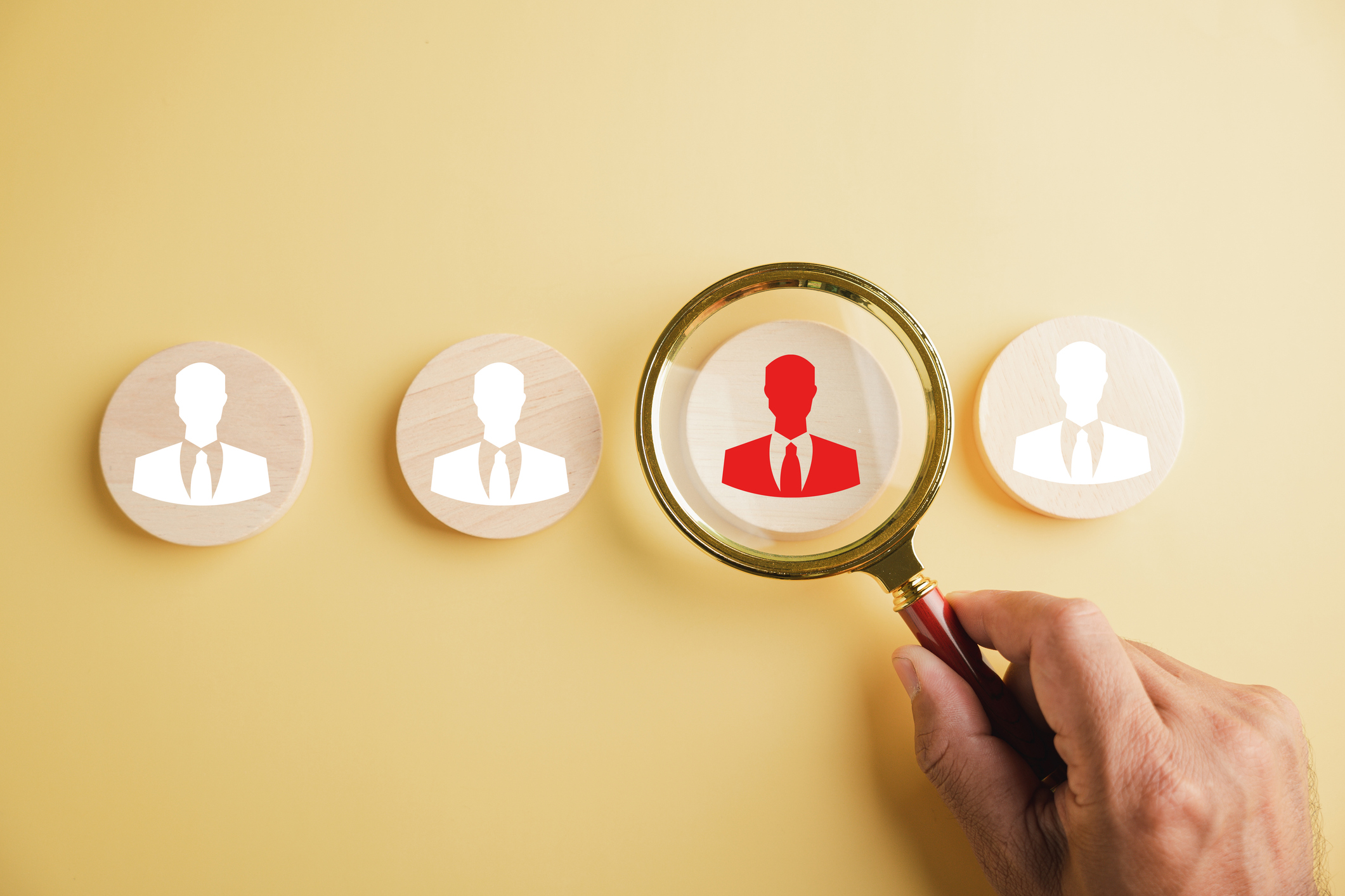 HRM insight Magnifier glass zooms in on manager icon in staff icons